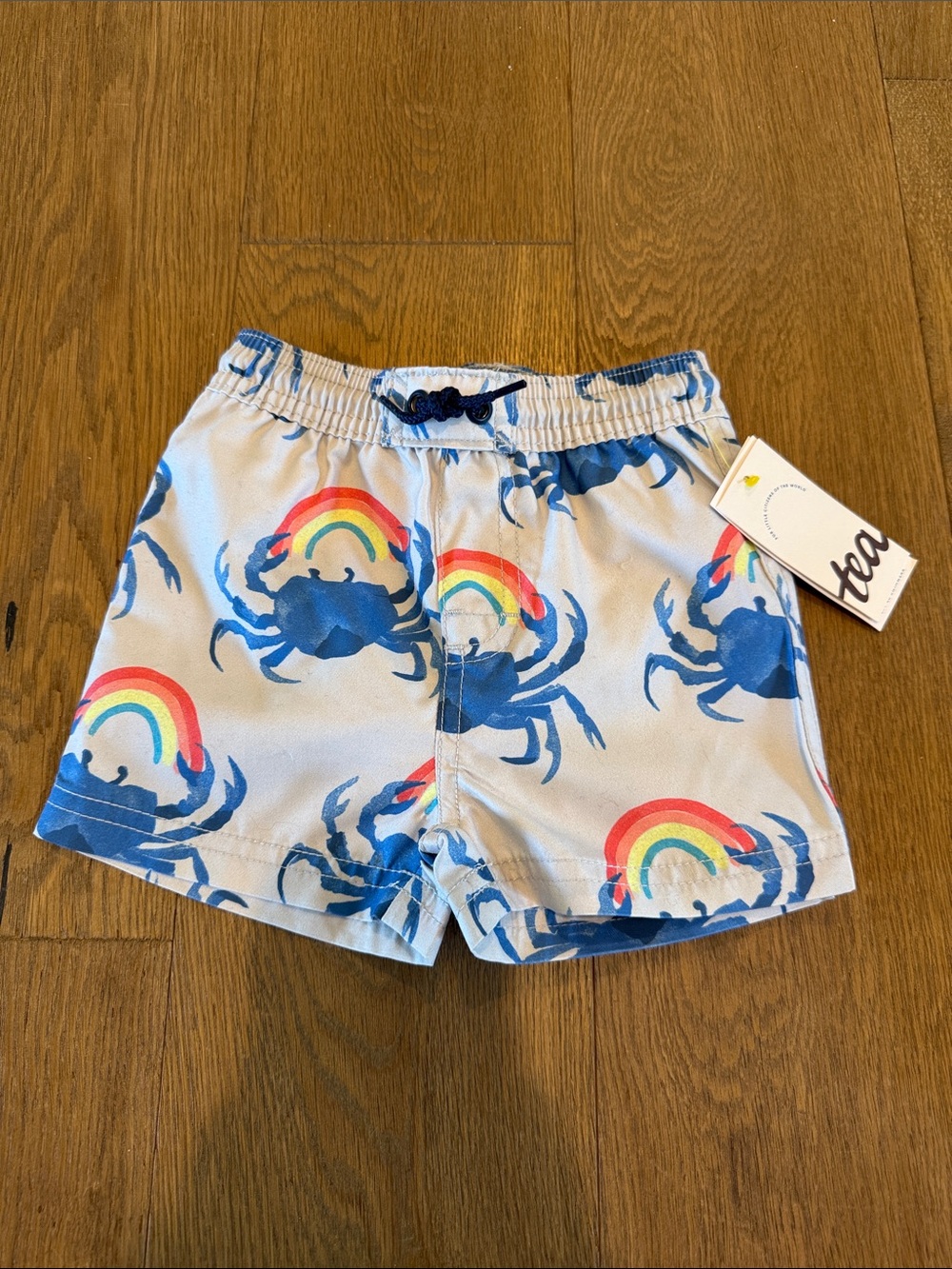 NWT Tea Collection  Shortie Baby Swim Trunks in Crab & Rainbow - 9-12 months